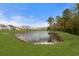 Scenic view of the community pond from the lush green backyard at 9727 Transplanter Cir, Ladson, SC 29456