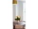 Cozy breakfast nook featuring a round table, two chairs, flowers, and natural light from the window at 10 Killians St, Charleston, SC 29403