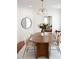 Bright dining room with a wooden table, seating for six, stylish light fixture, and a round mirror at 10 Killians St, Charleston, SC 29403
