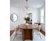 Bright dining room featuring modern light fixture, seating for six, hardwood floors, and natural light at 10 Killians St, Charleston, SC 29403