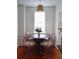 Charming dining room showcasing a round table with four chairs beneath a pendant light, bathed in natural light at 10 Killians St, Charleston, SC 29403