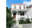 Charming two-story home featuring a red metal roof, welcoming front porch, and beautiful flower beds at 10 Killians St, Charleston, SC 29403