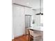 Bright kitchen featuring stainless steel refrigerator, sleek white cabinetry, and marble countertop island with seating at 10 Killians St, Charleston, SC 29403