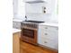 Modern kitchen with stainless steel oven, white cabinets, marble counters, and hardwood floors at 10 Killians St, Charleston, SC 29403