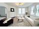 Spacious living room with a fireplace, stylish furniture, and ample natural light at 10 Killians St, Charleston, SC 29403