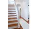 Bright staircase with hardwood stairs and white risers, leading to the upper level of the home at 10 Killians St, Charleston, SC 29403