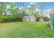 Expansive backyard with a lush lawn and a detached garage, offering ample space for outdoor activities and storage at 1003 Mountain Pine Rd, Moncks Corner, SC 29461
