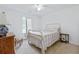 Bright bedroom with an antique metal bed frame, carpet, and natural light at 1003 Mountain Pine Rd, Moncks Corner, SC 29461