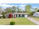 Charming single-story home with brick and siding, a well-manicured lawn, and a convenient attached garage at 1003 Mountain Pine Rd, Moncks Corner, SC 29461