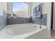 Bathroom featuring tub and window at 1005 Toland Dr # 44P, Saint George, SC 29477