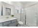 Bathroom featuring shower with glass door, toilet, sink and a window at 1005 Toland Dr # 44P, Saint George, SC 29477