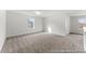 Spacious bonus room features neutral paint and carpet and natural light from two windows at 1005 Toland Dr # 44P, Saint George, SC 29477