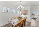 Bright dining room with a wooden table, six chairs, decorative chandelier, and natural light from multiple windows at 1005 Toland Dr # 44P, Saint George, SC 29477