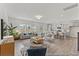 Open living room with hardwood floors, comfortable seating, a modern TV, a plant, and an open view of the kitchen at 1005 Toland Dr # 44P, Saint George, SC 29477