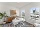 Bright office space featuring a white desk, woven decor, a striped rug, a houseplant, and natural light from two windows at 1005 Toland Dr # 44P, Saint George, SC 29477