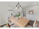 Elegant dining area with stylish light fixture and views into the open-concept kitchen at 1007 Toland Dr # 45P, Saint George, SC 29477