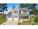 Charming two-story home with a manicured lawn, two car garage, and attractive curb appeal at 1007 Toland Dr # 45P, Saint George, SC 29477