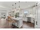 Bright kitchen with marble backsplash, island with seating, stainless steel appliances, and wood floors at 1007 Toland Dr # 45P, Saint George, SC 29477