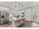 Modern white kitchen with stainless steel appliances, kitchen island, and stylish pendant lighting at 1007 Toland Dr # 45P, Saint George, SC 29477
