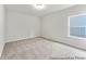 Bright bedroom with neutral carpeting, a flush mount light, and a view from the window at 1009 Toland Dr # 46P, Saint George, SC 29477