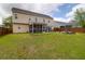 Expansive backyard featuring a screened porch, patio, and manicured lawn perfect for outdoor enjoyment at 106 Gathering Island Rd, Summerville, SC 29485
