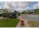 Charming community scene with golf carts, a beautiful home, and lush landscaping under a partly cloudy sky at 106 Gathering Island Rd, Summerville, SC 29485