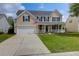 Inviting two-story home featuring a charming front porch and a well-maintained lawn at 106 Gathering Island Rd, Summerville, SC 29485