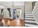 Open foyer with hardwood floors, staircase, and natural light from the front door at 106 Gathering Island Rd, Summerville, SC 29485