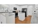 Well-lit kitchen with granite countertops, white cabinets, and black appliances at 106 Gathering Island Rd, Summerville, SC 29485