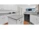 Modern kitchen with granite countertops, white cabinets, and open layout into living area at 106 Gathering Island Rd, Summerville, SC 29485