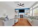 Cozy living room with fireplace, built-ins, ceiling fan, and hardwood floors at 106 Gathering Island Rd, Summerville, SC 29485