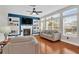 Sun-filled living room with fireplace, built-ins, hardwood floors and large windows at 106 Gathering Island Rd, Summerville, SC 29485