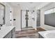 Main bathroom with stylish tiled shower, double sink vanity, and natural light at 106 Gathering Island Rd, Summerville, SC 29485