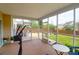 Inviting screened porch with exercise equipment and views of a beautifully landscaped backyard and patio at 106 Gathering Island Rd, Summerville, SC 29485