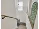 Clean stairway with a bronze bannister, window, and unique decor at 106 Gathering Island Rd, Summerville, SC 29485