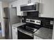 Modern kitchen with stainless steel appliances, granite countertops, and white cabinets at 108 Sandlewood Dr, Summerville, SC 29483