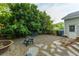 Backyard with stone pathway and chair next to the home with exterior door at 1111 Kilarney Rd, Mount Pleasant, SC 29464