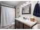 Traditional bathroom features dark wood vanity, neutral walls, and a shower with patterned curtain at 1111 Kilarney Rd, Mount Pleasant, SC 29464