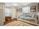 Cozy bedroom has hardwood floors, ample natural light, and features charming decor with South Carolina prints at 1111 Kilarney Rd, Mount Pleasant, SC 29464