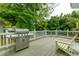 A spacious wooden deck with a grill and comfortable seating, ideal for outdoor entertaining and relaxation at 1111 Kilarney Rd, Mount Pleasant, SC 29464