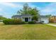 Charming single-story home with a manicured lawn, flowering bushes, and an attached garage at 1111 Kilarney Rd, Mount Pleasant, SC 29464
