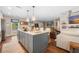 The kitchen island has stainless appliances, quartz counters and is part of an open floorplan at 1111 Kilarney Rd, Mount Pleasant, SC 29464