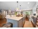 An island kitchen has pendant lighting, quartz countertops, and stainless appliances at 1111 Kilarney Rd, Mount Pleasant, SC 29464