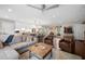 An open-concept living room boasts hardwood floors, a ceiling fan, and seamlessly connects to a modern kitchen at 1111 Kilarney Rd, Mount Pleasant, SC 29464
