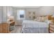 Bright bedroom featuring natural textures, framed botanical prints, and light wood furniture at 112 Coastline St, Ridgeville, SC 29472