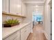 Bright hallway with white cabinets, quartz countertops, and a view into the dining area at 112 Coastline St, Ridgeville, SC 29472