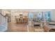 Open-concept living space with a modern kitchen, dining area, and seating at 112 Coastline St, Ridgeville, SC 29472