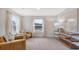 Comfortable sitting area with plush chairs and a view of the lush greenery outside at 112 Coastline St, Ridgeville, SC 29472
