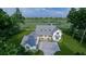 Aerial view of a charming two-story farmhouse with an attached two-car garage by a pond at 116 Peninsula Dr, Ravenel, SC 29470