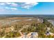 An aerial view of a residential area surrounded by water and trees with blue sky at 116 Peninsula Dr, Ravenel, SC 29470